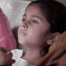 a close up of a young girl 's face with the words one day by saan on the bottom right