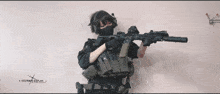 a person holding a gun with a x on the bottom right corner