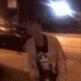 a blurry photo of a person with a cat on their shirt