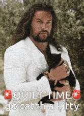 a man in a white suit is holding a black cat with the words quiet time go catch a kitty above him
