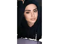 a woman wearing a black hoodie and headphones