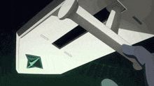 a hand is holding a piece of paper with a green diamond on it