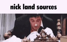a man in a suit is sitting in a chair with a napkin on his nose and the words nick land sources above him .
