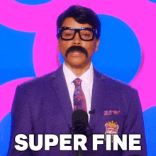 a man with a mustache and glasses stands in front of a microphone with the words super fine above him