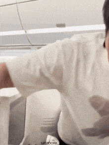a man wearing a white shirt with the word upboom on the bottom