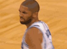 a man with a beard wearing a basketball jersey that says orlando
