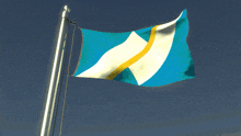 a blue and white flag with a yellow stripe is flying in the wind