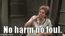 a woman is sitting in a wheelchair smoking a cigarette and says `` no harm no foul '' .