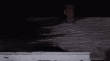 a brick roof with a chimney on top of it