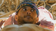 a man wearing a headband that says ' survival ' on it