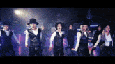 a group of dancers are performing in front of a sign that says no smoking