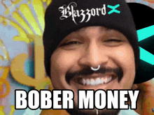 a man with a beard wearing a black beanie with the word blazzard on it