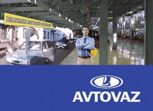 a man with his arms crossed is standing in front of a sign that says avtovaz