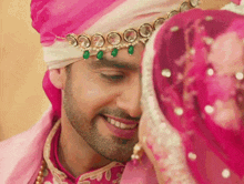 a close up of a man wearing a turban and necklace