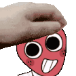 a hand is scratching a cartoon character 's head .