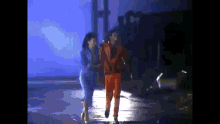 a man and a woman are walking in the dark