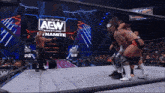 a group of men are wrestling in front of a sign that says all elite wrestling dynamite
