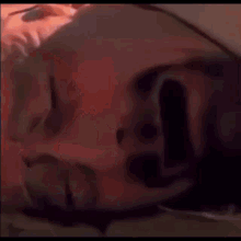 a person is laying on the ground with their head on the ground .