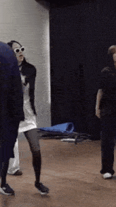 a group of people are dancing in a room .