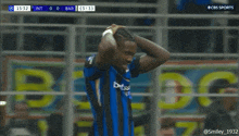a man in a betsson sport jersey holds his head