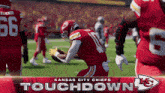 a kansas city chiefs touchdown poster with a football player in the background