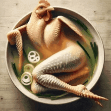 a chicken is sitting in a bowl of soup with vegetables .