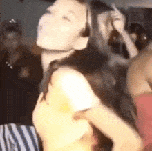 a woman wearing headphones is dancing in a crowded room .