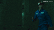 a man with a bandage on his head is running in a dark room with arrow presents on the bottom