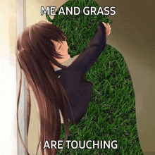 a girl is kissing a silhouette of a man made out of grass .
