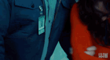 a man in a blue jacket has a patch on his shoulder that says hw