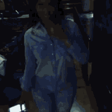 a blurry picture of a person walking down a street at night