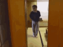 a blurry picture of a man taking a picture of another man in a hallway .