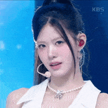 a close up of a woman 's face with the kbs logo visible