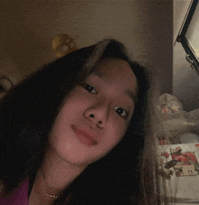 a girl with long hair is taking a selfie in front of a refrigerator