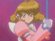 a girl in a pink outfit is holding a purple wand