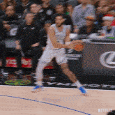 a man dribbles a basketball on a court with a netflix logo in the corner