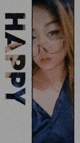 a woman wearing glasses is standing next to a sign that says happy .