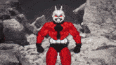 a pixel art of an ant man standing on a rocky surface