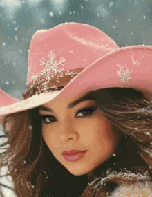 a woman in a pink hat with snowflakes on it