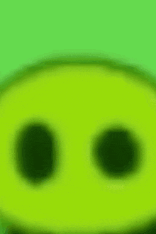 a close up of a green pig 's face with a blurry background