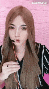 a woman wearing headphones and a starmaker logo on the bottom right