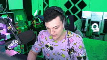 a man wearing headphones is sitting in front of a microphone in a room .