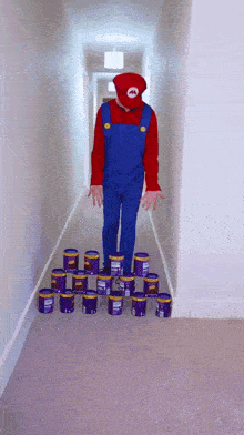 a person in a mario costume is standing on a stack of purple buckets