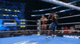 two men are wrestling in a wrestling ring with the word smackdown on the side of the ring .
