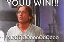 a man in a white shirt is standing in front of a sign that says you win
