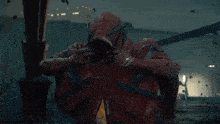 a man in a red robe with a cross on his face