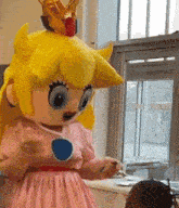 a mascot dressed as princess peach is standing in front of a window