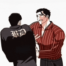 a man in a striped shirt has the letter b on the back of his jacket .