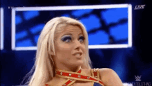 a woman in a wrestling outfit is making a funny face on a live broadcast .