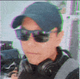 a man wearing sunglasses and headphones has a glitch effect